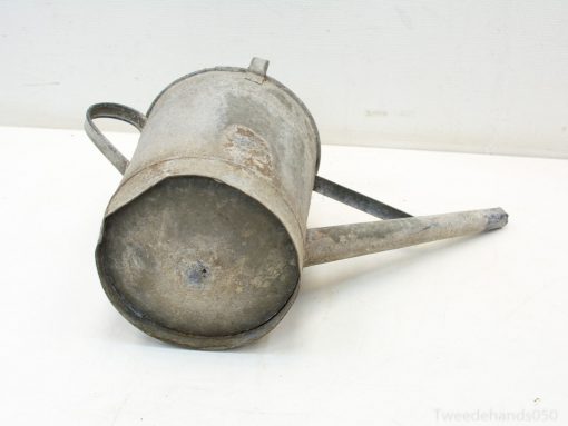 Rustic vintage metal watering can with character, perfect for gardening and home decor.