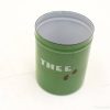 Vintage green tin can with white THEE lettering, ideal for decoration or storage.