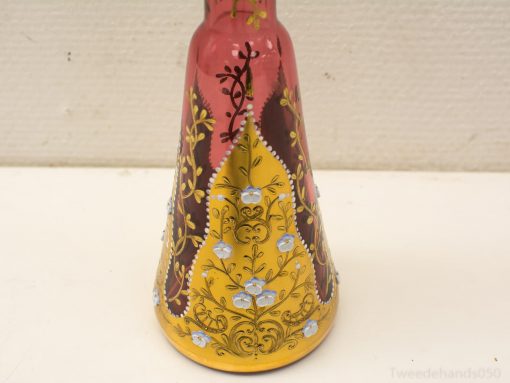 Vibrant conical vase with intricate floral patterns and golden accents, perfect for stylish decor.