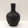 Elegant black vase with textured finish and shimmering accents for modern decor.
