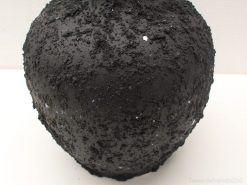 Artistic black vase with textured surface and blue-white star accents for stylish decor.
