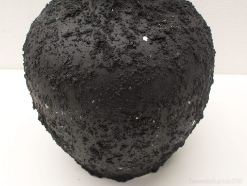 Artistic black vase with textured surface and blue-white star accents for stylish decor.