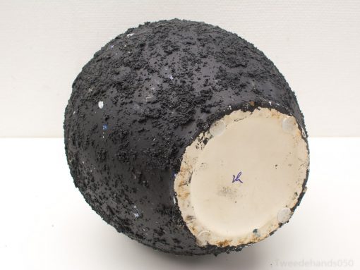 Textured black vase with colorful speckles and a smooth base for stability.
