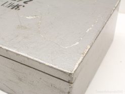 Vintage metal box with character, showcasing wear and handwritten notes for unique decor and storage.