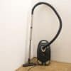 Stylish black vacuum cleaner with silver accents, perfect for modern homes and efficient cleaning.
