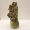 Elegant woman sculpture with stairs, embodying growth and natures harmony for garden decor.