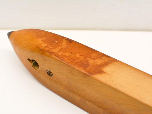 Handcrafted wooden fishing lure with black tip, showcasing traditional design and elegant craftsmanship.