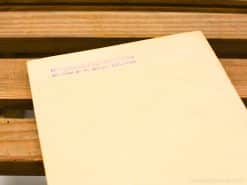 Historical document Delftse Automobiel Motoren by E.H. Mulder on rustic wooden surface.