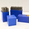 Vintage metal stamping sets in blue cases for precise crafting and organization.