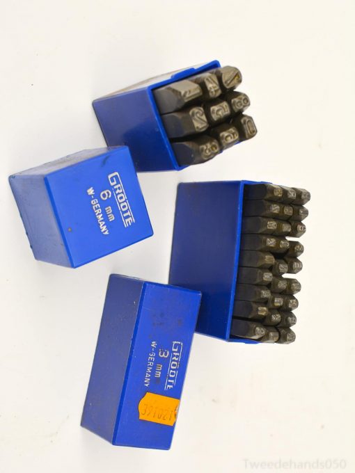 Quality 6mm and 3mm metal stamps in durable blue boxes for precision engraving tasks.