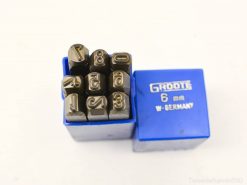 Vintage metal stamping set in blue case, featuring durable steel stamps numbered 0 to 8.