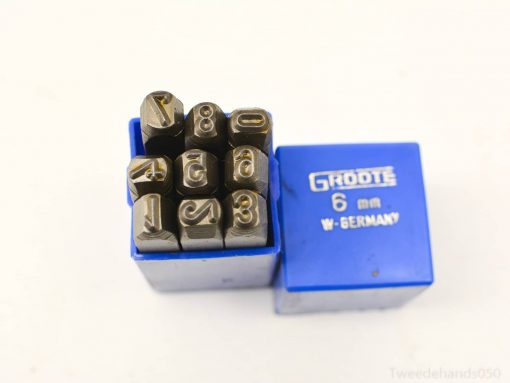 Vintage metal stamping set in blue case, featuring durable steel stamps numbered 0 to 8.