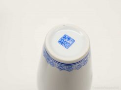 Elegant blue and white porcelain cup featuring intricate floral and geometric patterns.