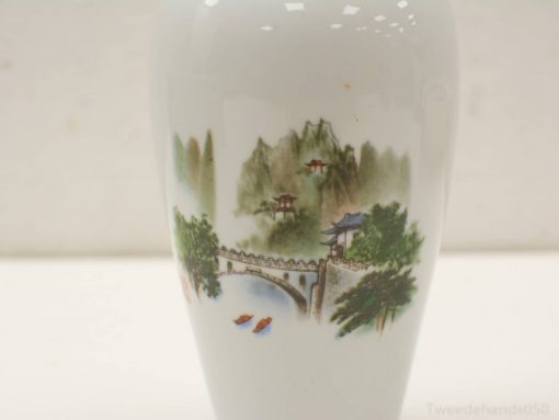 Elegant porcelain vase featuring serene landscape, bridge, and vibrant colors for refined decor.