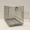 Sturdy metal dog crate with open door and removable tray for safe pet care.