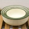 Timeless vintage nesting bowls with green rims, ideal for mixing and serving in your kitchen.