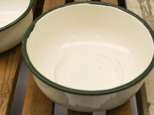 Charming vintage enamel bowl with green trim, perfect for nostalgic kitchen decor and use.