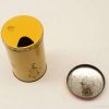 Charming vintage yellow tin canister with whimsical illustration and lid, perfect for storage.