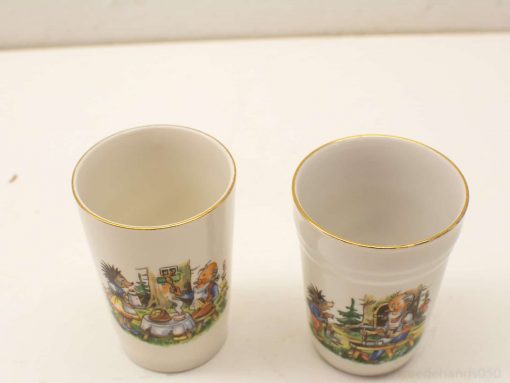 Colorful ceramic cups featuring playful animal scenes, ideal for display or everyday enjoyment.