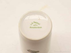 Vintage porcelain cup by v.d. Peppel & Co, Amsterdam, showcasing classic craftsmanship and charm.