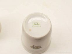 Elegant Geha ceramic cup with vintage charm, featuring glossy finish and subtle green branding.