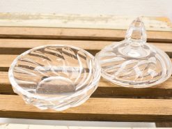 Elegant glass bowl with intricate patterns and lid, perfect for display or storage.