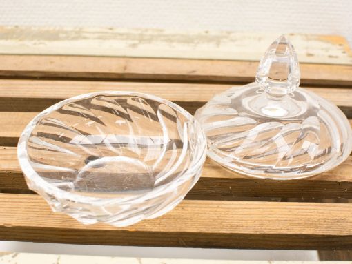 Elegant glass bowl with intricate patterns and lid, perfect for display or storage.