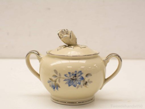 Elegant porcelain sugar bowl with rosebud lid and delicate hand-painted floral design.