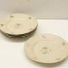 Charming vintage porcelain plates with floral designs for elegant dining and special occasions.