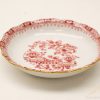 Elegant porcelain dish with intricate red designs and gold accents, perfect for display or dining.