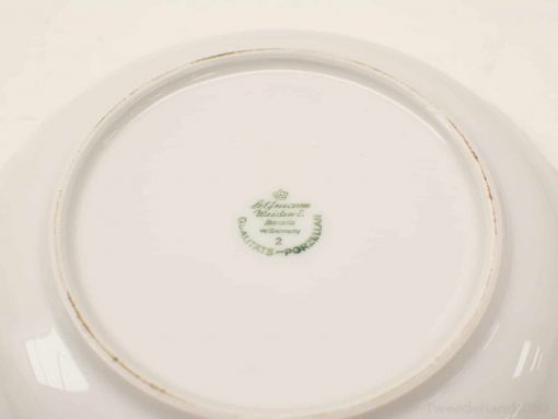 Elegant Alfred Meakin porcelain plate with crown emblem, showcasing refined craftsmanship and historical charm.