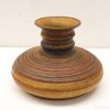 Handcrafted vintage ceramic vase in warm earthy tones, ideal for floral displays or decor.