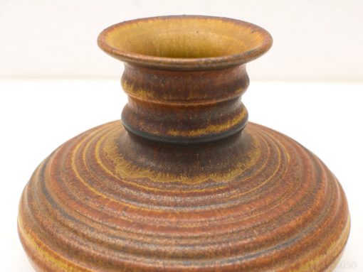 Elegant vintage pottery vase with unique textures and rich earthy colors, ideal for collectors.
