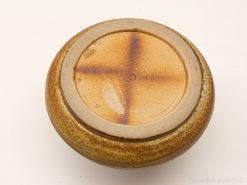 Rustic handmade ceramic bowl in earthy hues, ideal for serving or decorative use.