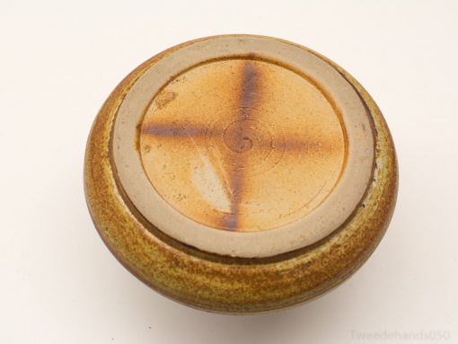 Rustic handmade ceramic bowl in earthy hues, ideal for serving or decorative use.
