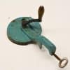 Vintage turquoise kitchen tool with wooden handle, ideal for mixing ingredients and adding charm.
