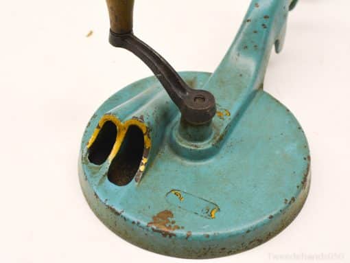 Vintage teal mechanical tool with wooden handle, showcasing unique character and nostalgic charm.