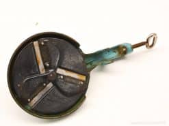 Vintage food chopper with blue handle and sharp blades, perfect for culinary enthusiasts.