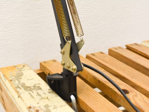 Vintage adjustable desk lamp with sturdy hinge and elegant spring, ideal for industrial decor.