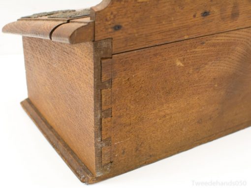 Antique wooden box with dovetail joints, combining elegance and functionality for treasured storage.