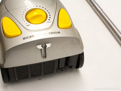 Sleek 1800W silver and yellow vacuum cleaner with adjustable suction and easy-glide wheels.