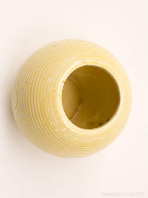 Elegant yellow ceramic vase with ribbed texture for versatile home decor.