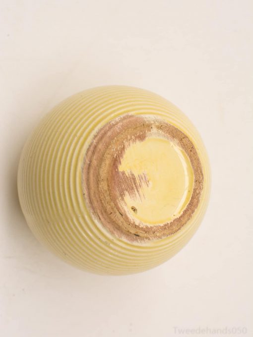 Handcrafted yellow ceramic bowl with textured ridges, perfect for decor and everyday use.
