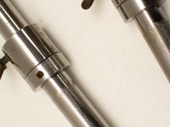 Polished metal tubes with knurled grip and adjustable clamps for versatile applications.