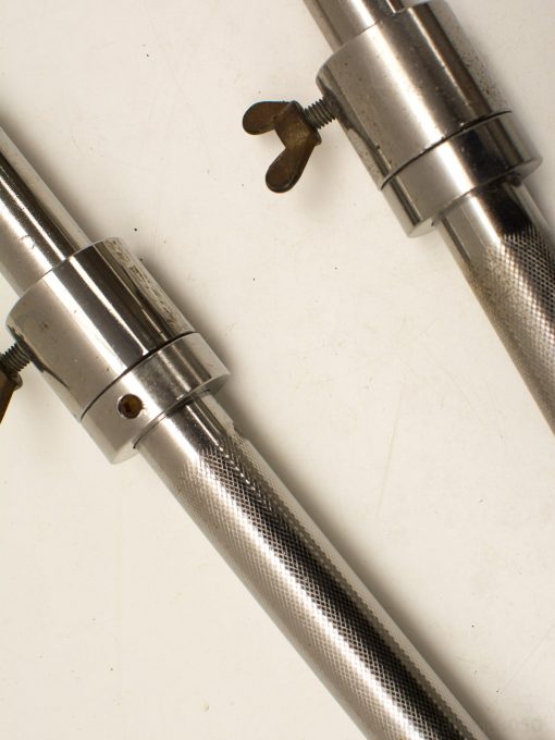 Polished metal tubes with knurled grip and adjustable clamps for versatile applications.