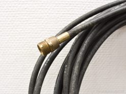 Durable black coiled hose with brass connector, perfect for high-pressure industrial applications.