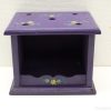 Charming purple wooden storage box with floral motifs and circular openings for organization.