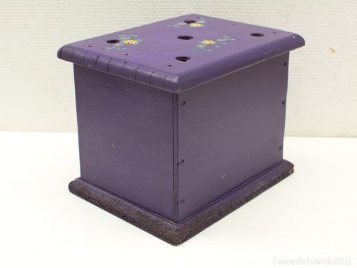 Vibrant purple wooden box with floral designs and ventilation holes for plants or decorative storage.
