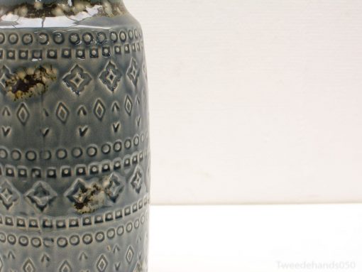 Elegant vintage ceramic vase with geometric patterns in soothing blue tones.