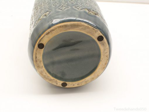 Captivating blue ceramic vase with geometric patterns, golden rim, and contrasting green interior.